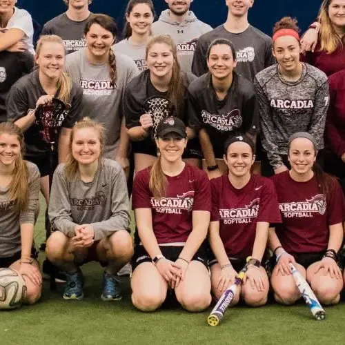 Team members of different Arcadia sports together on a field