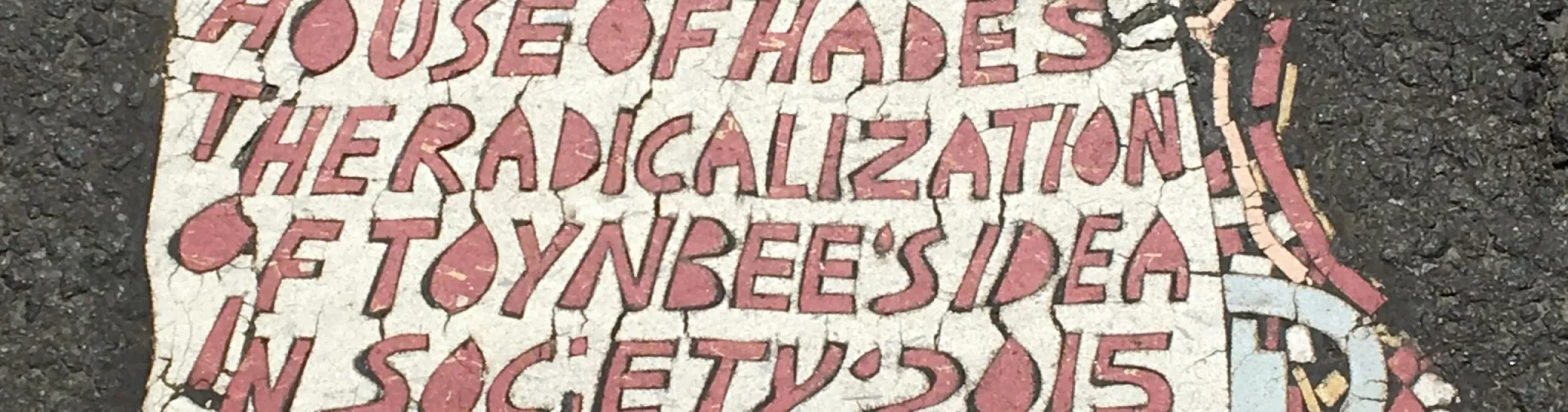 Concrete that has "House of Hades The Radicalization of Toynbee's Idea in Society'2015" painted on it in red