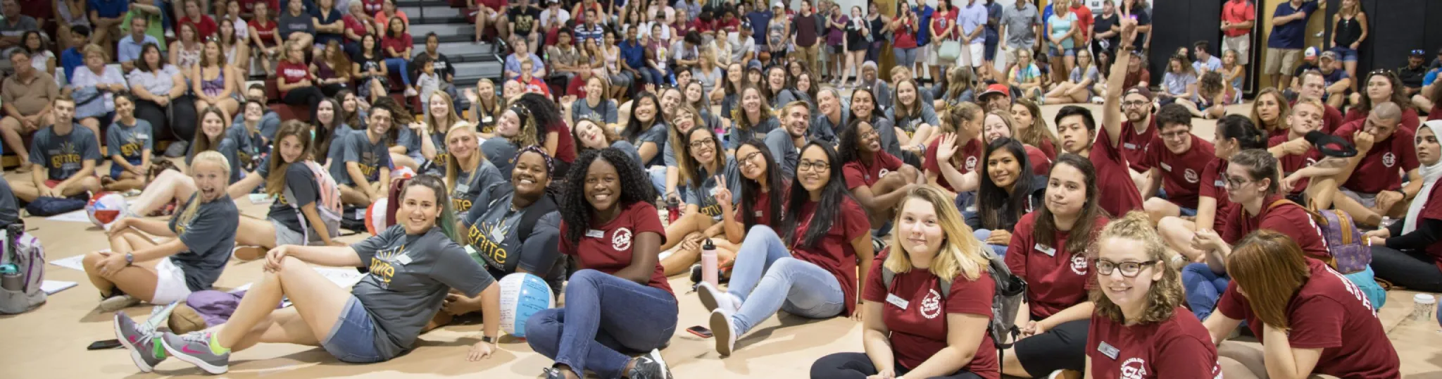 The gym filled with students with orientation leaders in the front of the picture.