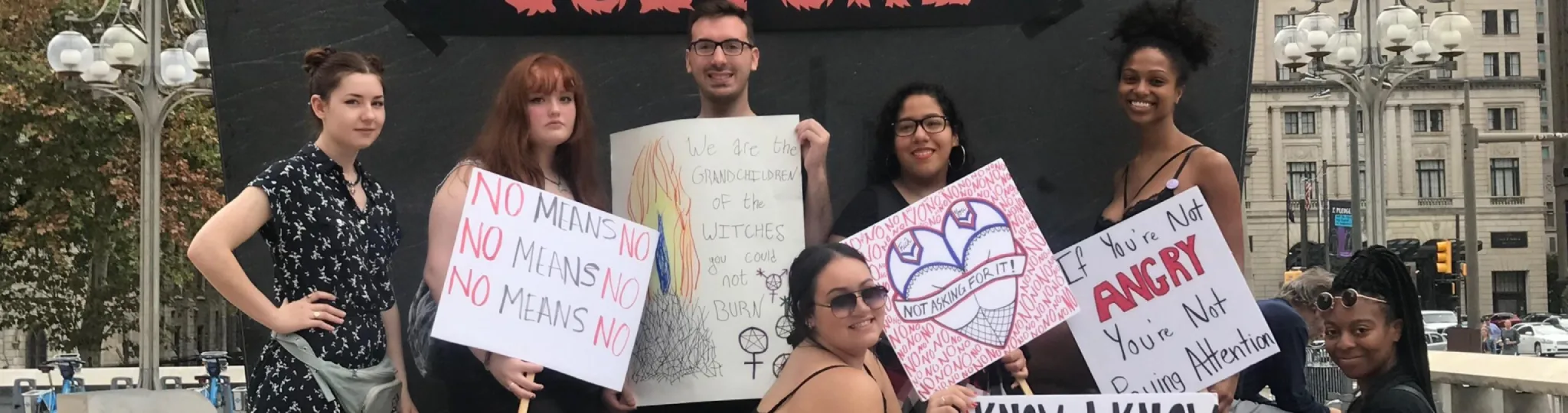 A group holding signs in support of feminism