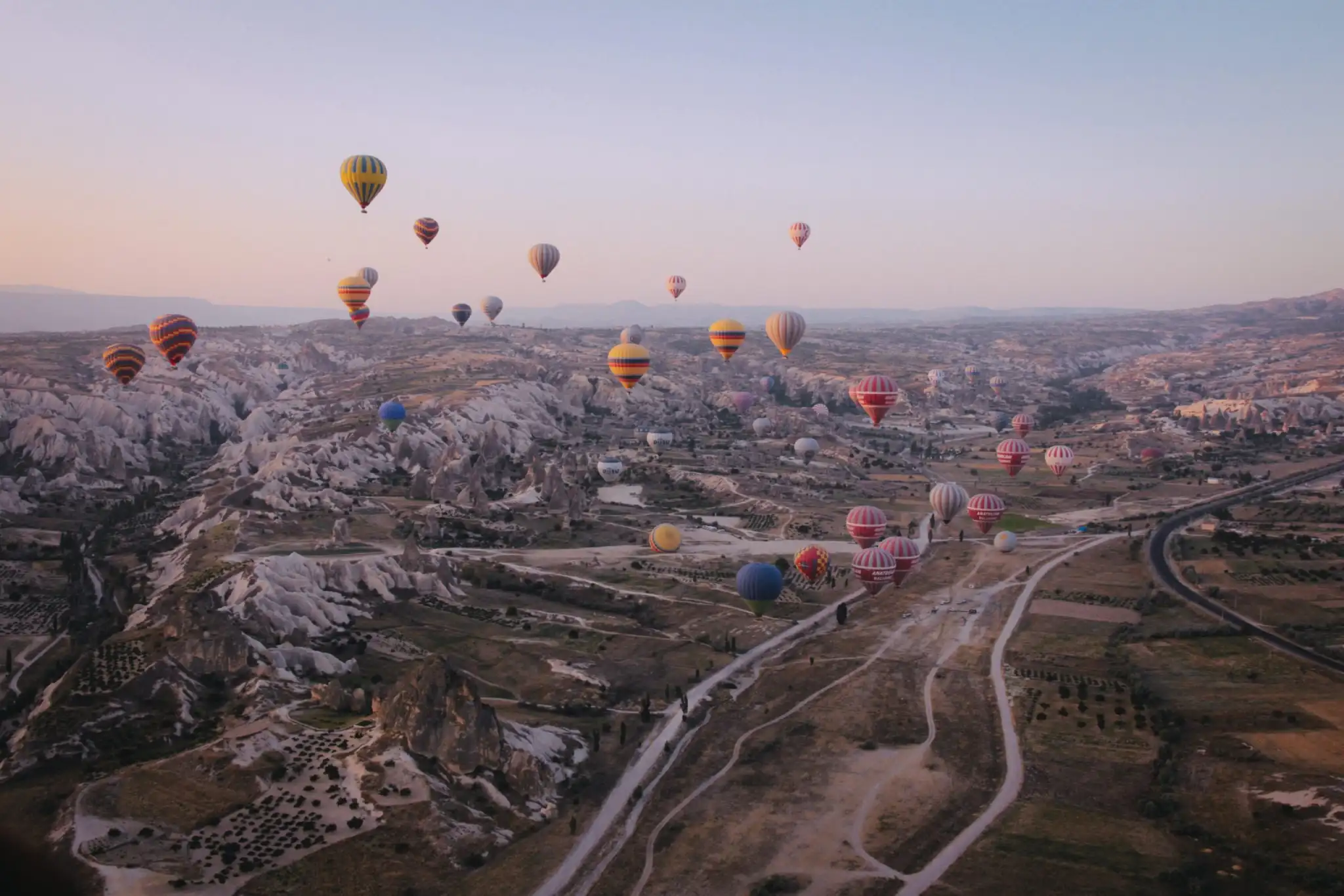 hot air balloons floating over mountains