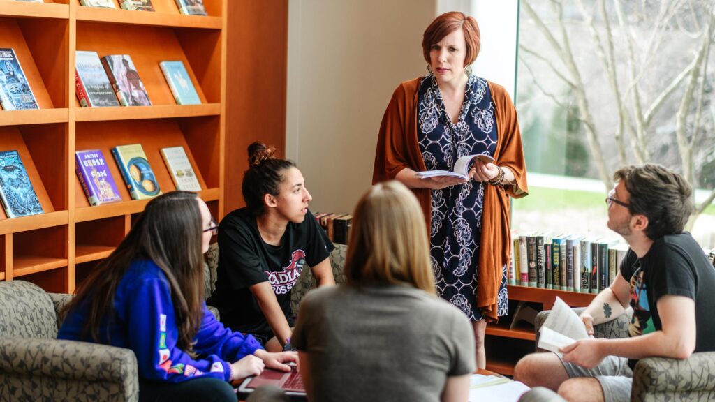 A teacher leads an informal discussion in the library.
