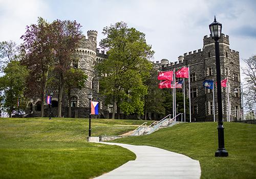 Grey Castle on a cloudy day with flags billowing