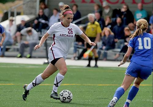 An Arcadia soccer player kicking a ball