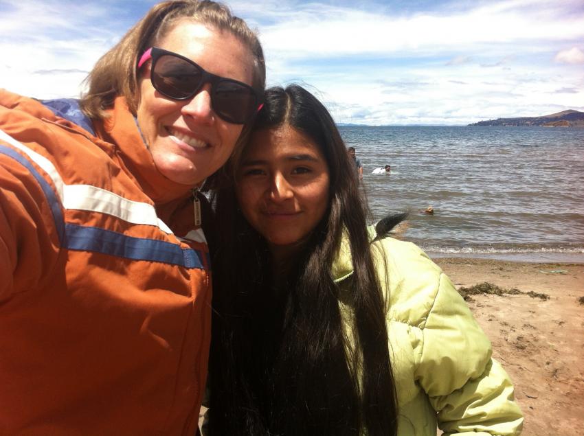 An adult and child taking a picture together in Peru.