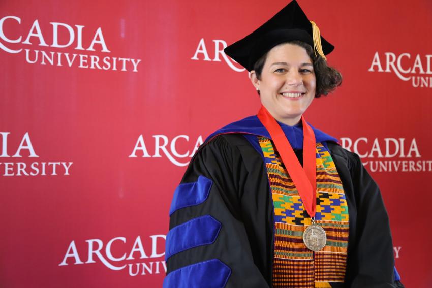 Woman in Commencement regalia.