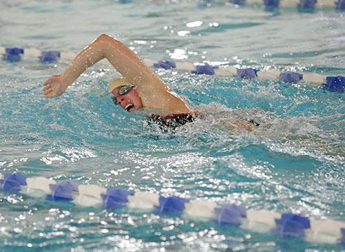 A swimmer doing a lap in the pool.