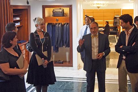 MBA students stand in a men's suit shop in Rome, Italy.