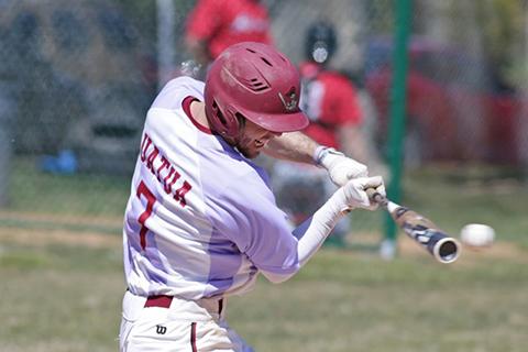 An Arcadia men's baseball player swings at the ball