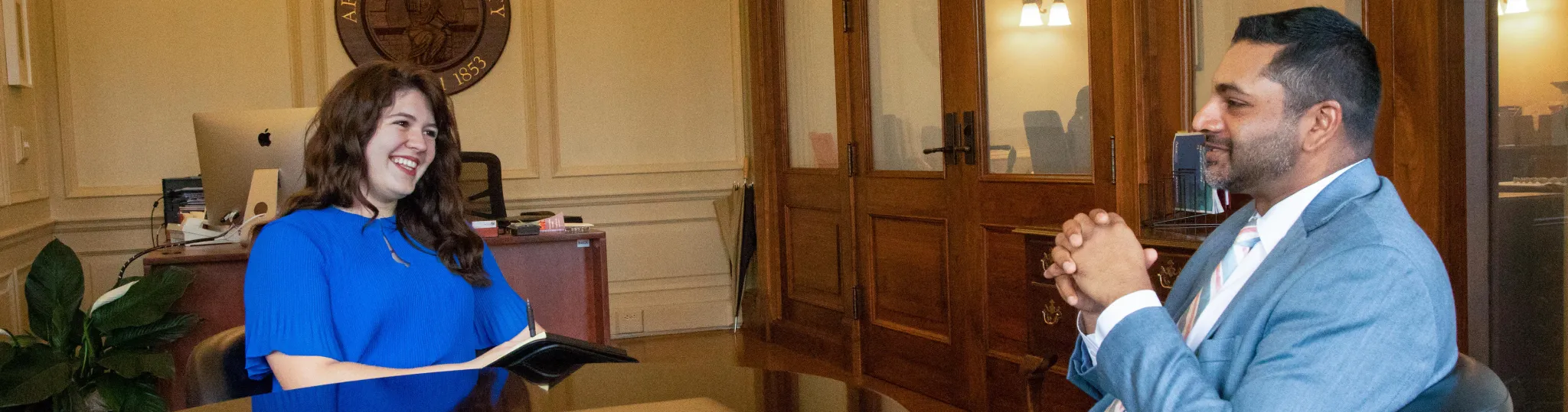 A woman talking with President Nair.