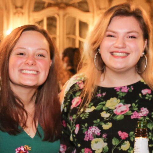 Female students celebrate an event in the Mirror Room.