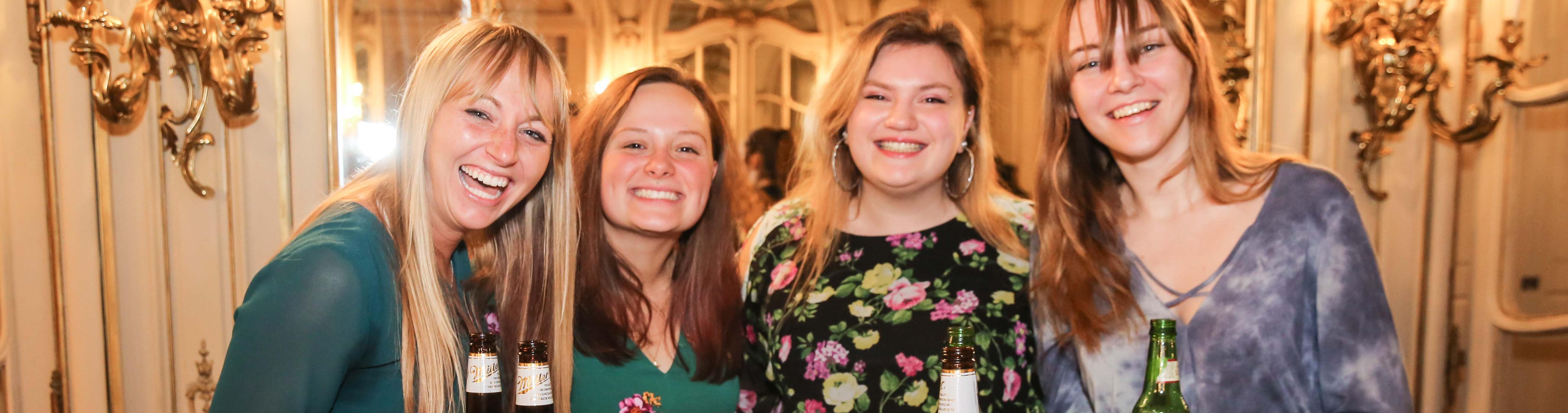 Female students celebrate an event in the Mirror Room.