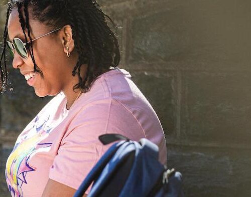 A student sitting with her laptop