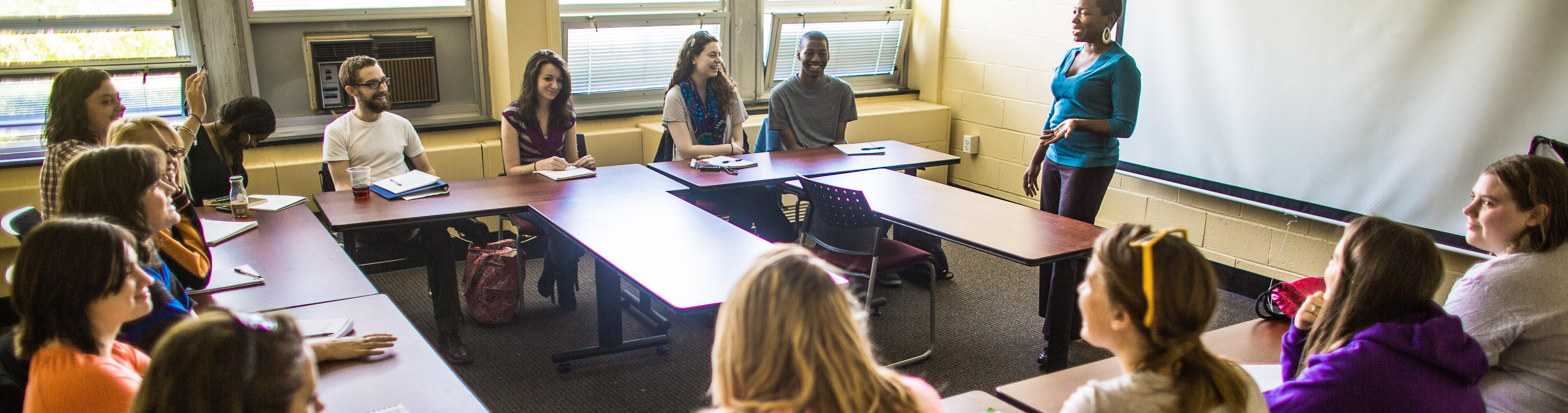 Student standing at front of classroom.