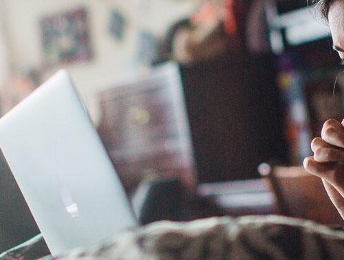 A student watching a movie on her laptop