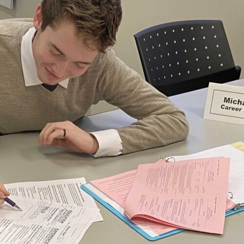 A career peer advisor works with a fellow student