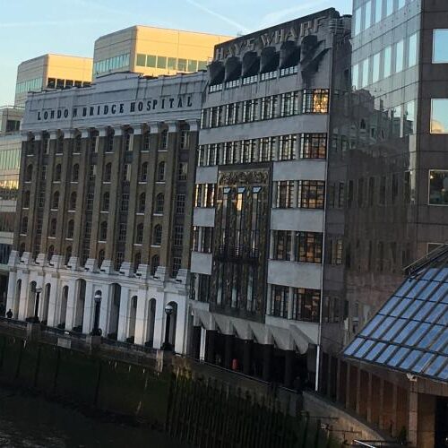 View of buildings and London Tower Bridge from River Thames.