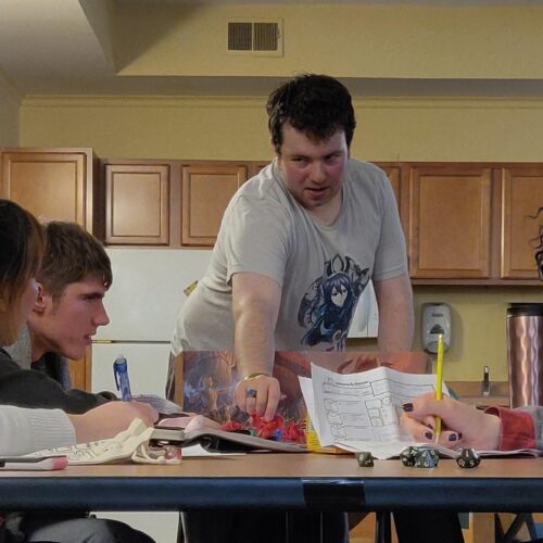 Six students gathered around a table