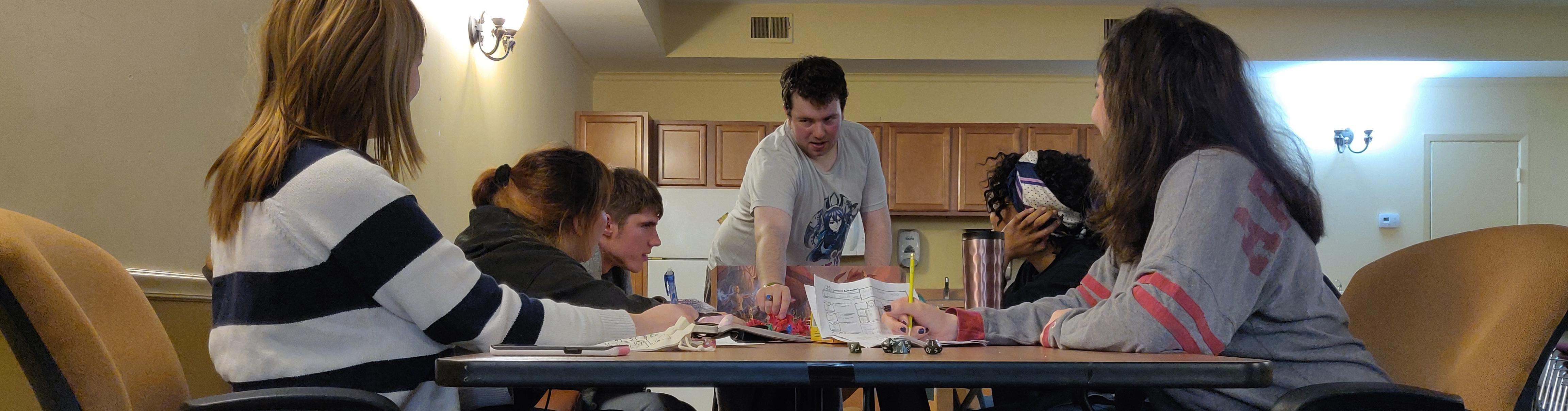 Six students gathered around a table