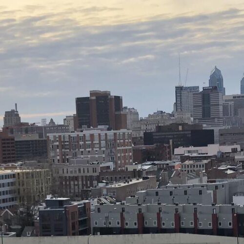 A student overlooking the Philly city on a windy day