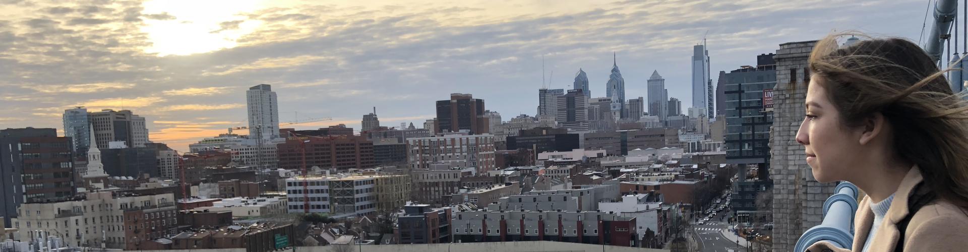 A student overlooking the Philly city on a windy day