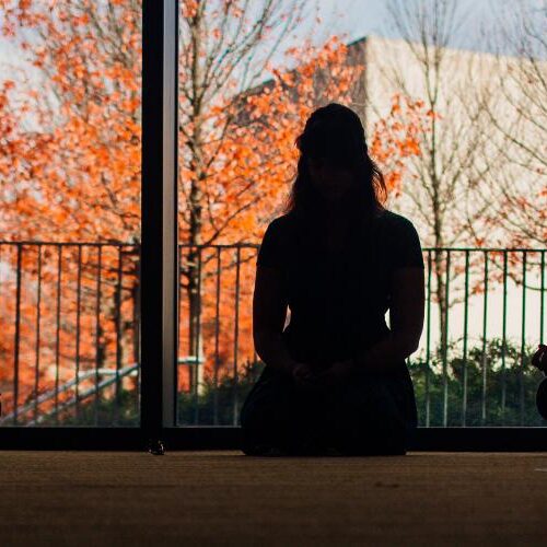 Group of students meditating in Stein Fireplace Lounge.