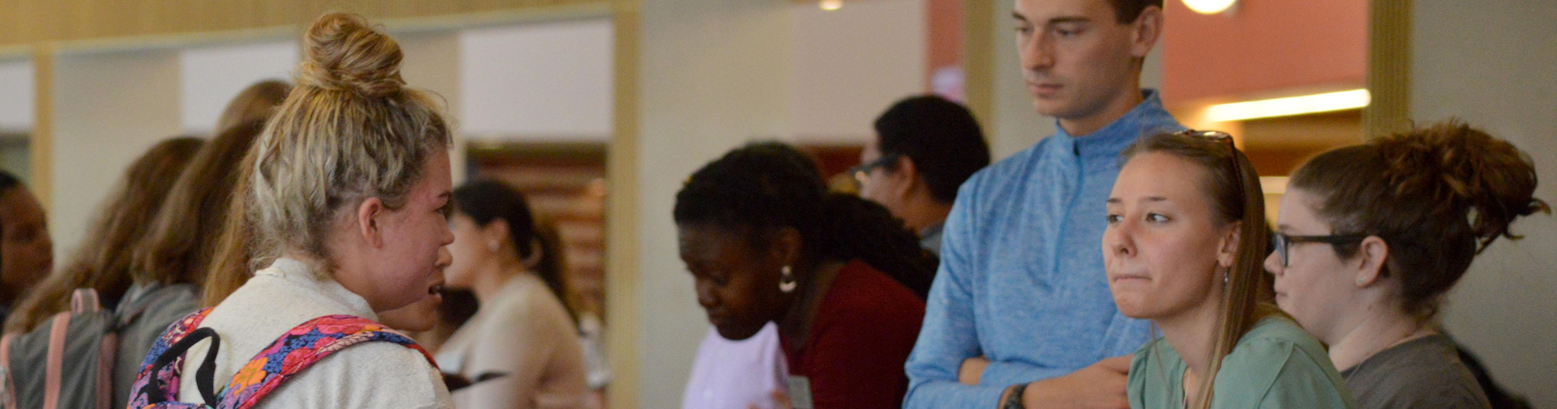 A group of students at a study abroad table.