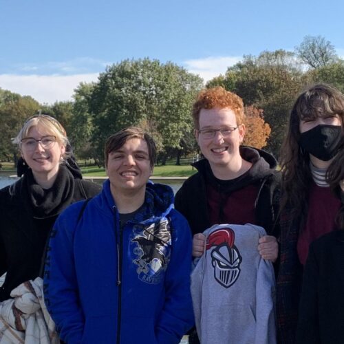 A group visiting DC with the Washington Monument in the background