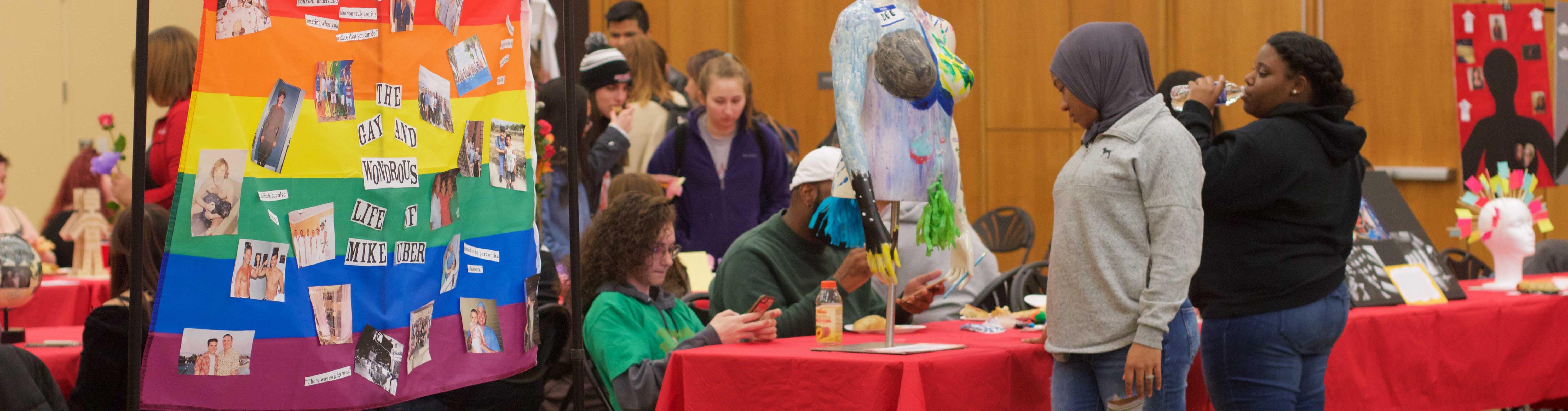 A photo of art on display in the Great Room. Specific artwork in this photo display pride in LGBTQ.