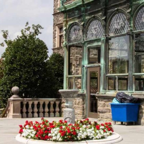 Side entrance of Grey Towers Castle with flowers in the center