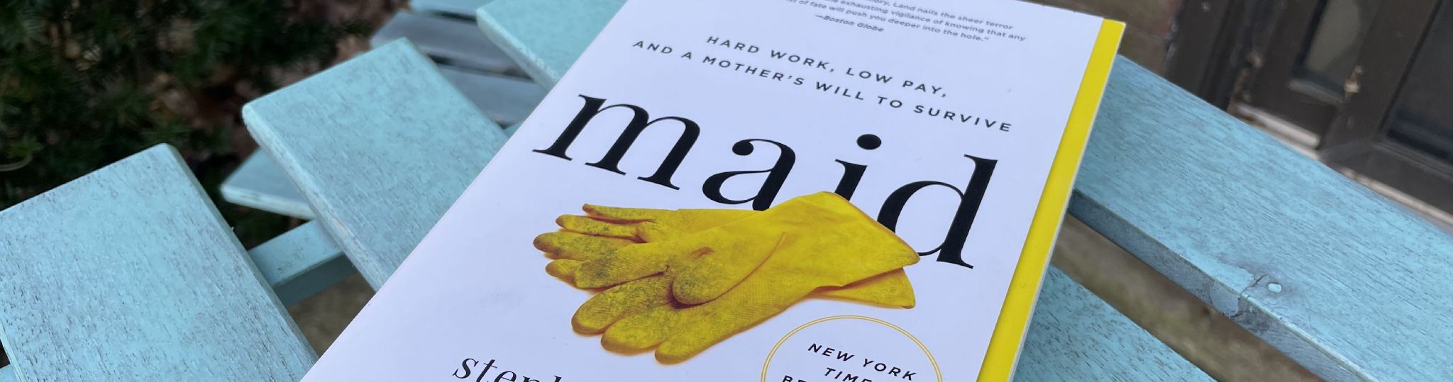 A pamphlet that reads "maid" with yellow gloves