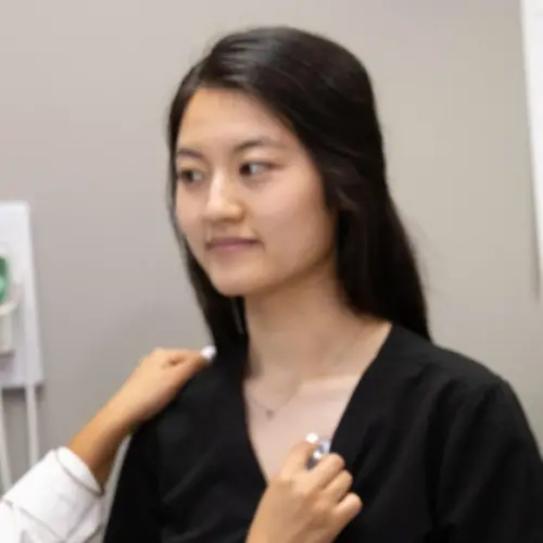 A woman getting checked on by two nurses