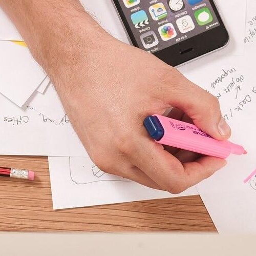 Stock imagery of someone highlighting a paper.