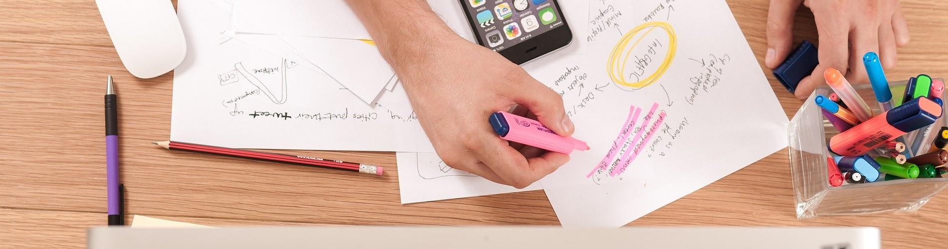 Stock image of someone higlighting a piece of paper