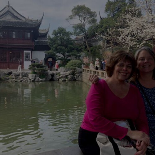 A collage of many Aracadia students abroad and on campus, centered is a pair of women with a temple in the background.