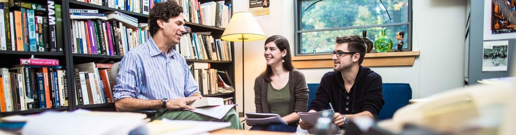 A photo of three people having a conversation.