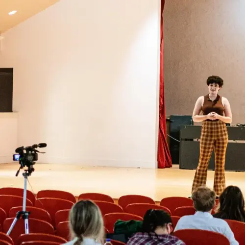 A person giving a speech in an auditorium