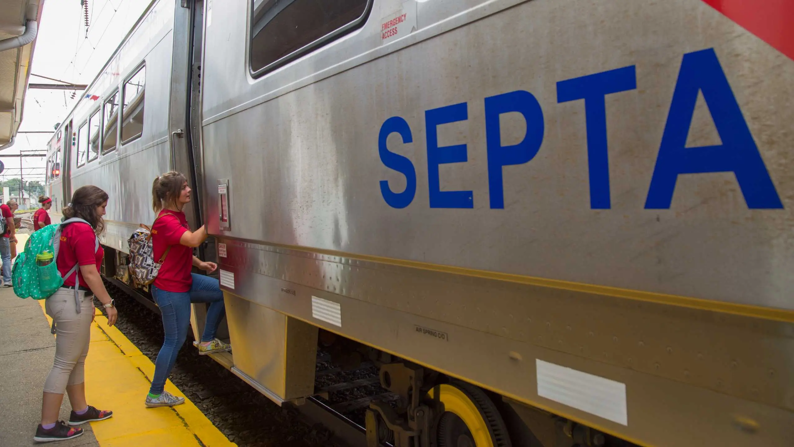 Two students board the local commuter train.