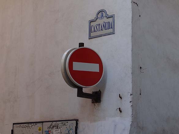 a photo of a do not enter graphic attached to the corner of a white wall