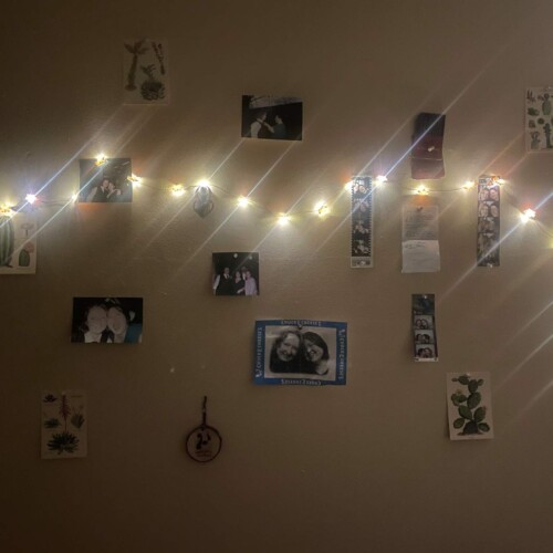 twinkle lights and photos on a wall