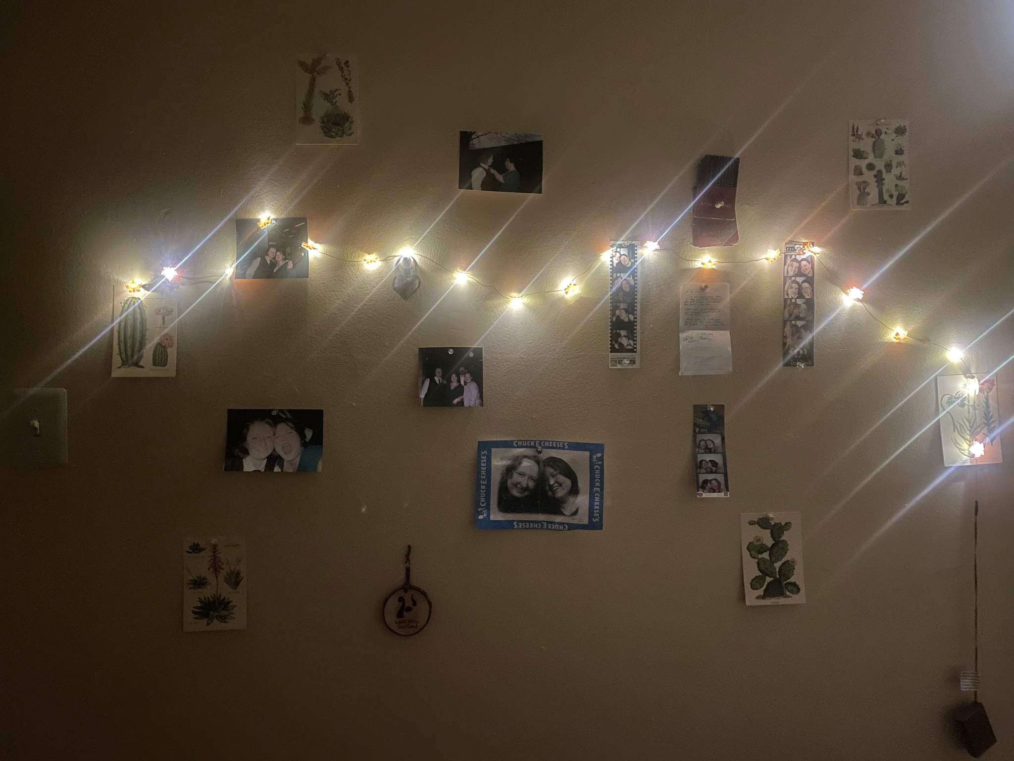 twinkle lights and photos on a wall