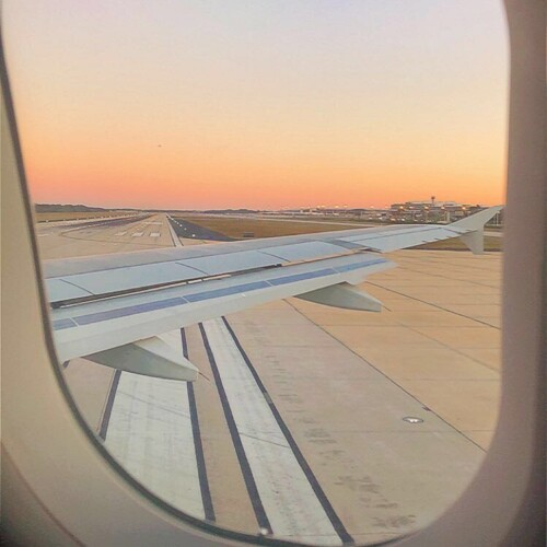 a sunset from the vantage point of a plane window