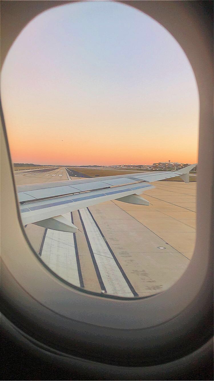 a sunset from the vantage point of a plane window