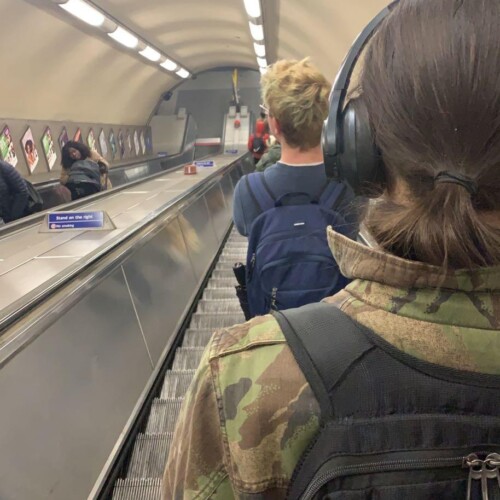 People on an escalator at an airport