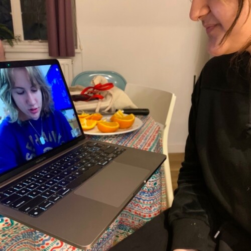 A student video chats with a loved one on a computer