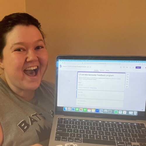 Jo Creollo '24 holds a laptop open to the CTLMmid-semester feedback form