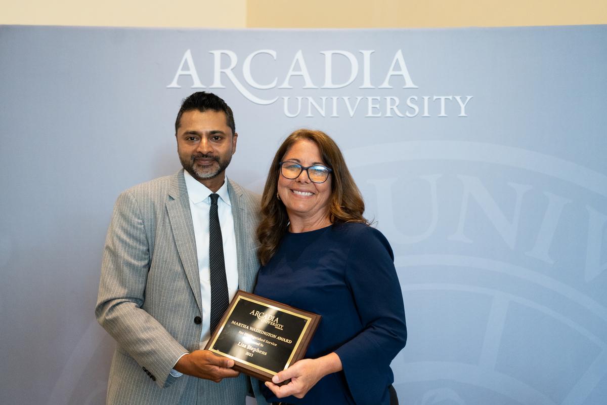 Lisa Stephens receives award from President Ajay nair