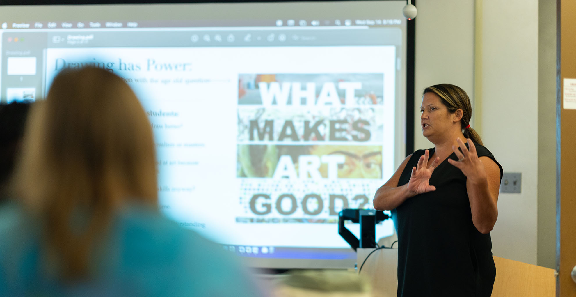 Professor instructs graduate education class in art education.