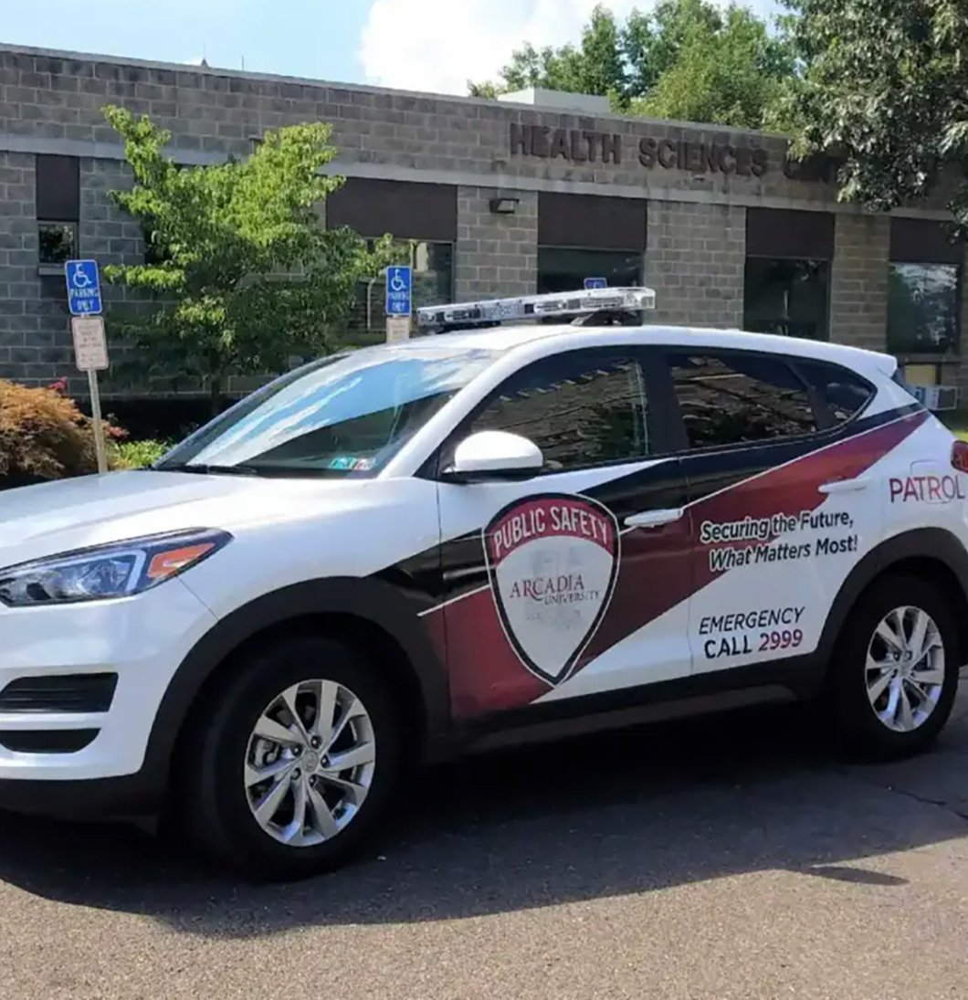 An Arcadia Public Safety vehicle parked in front of health services on campus.