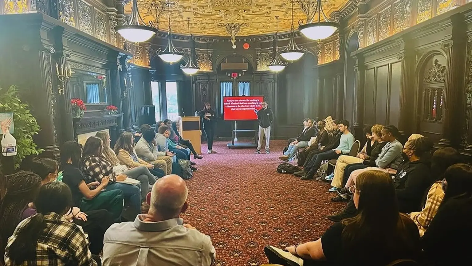 The Social Action and Justice Education Fellowship Program (SAJE) holds a meeting in the castle with a live presenter.